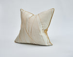 Load image into Gallery viewer, Decorative pillow with gold accents on a light gray background
