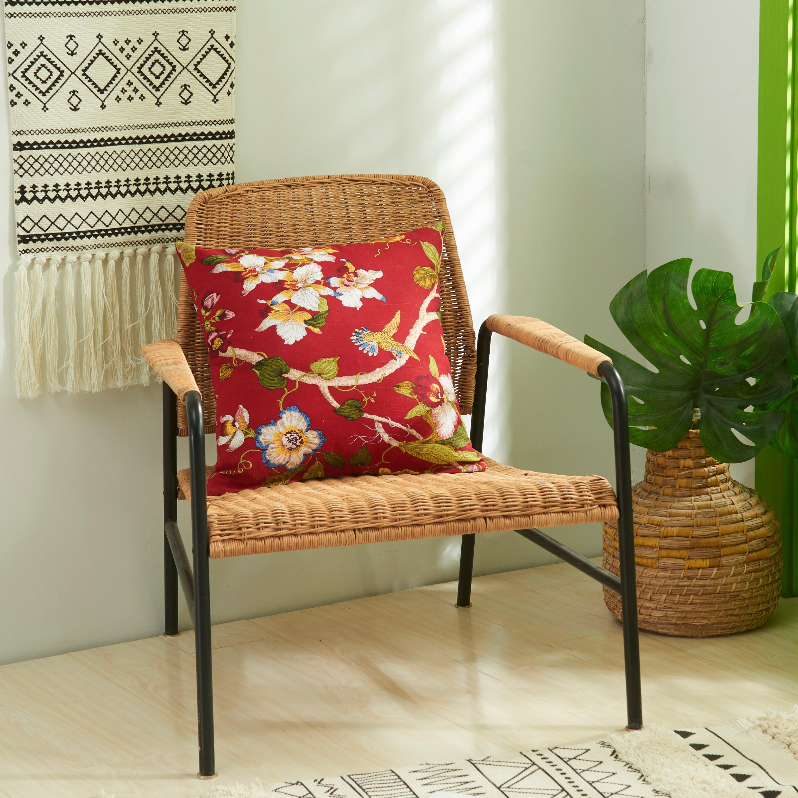 Red floral printed cushion covers placed on a chair