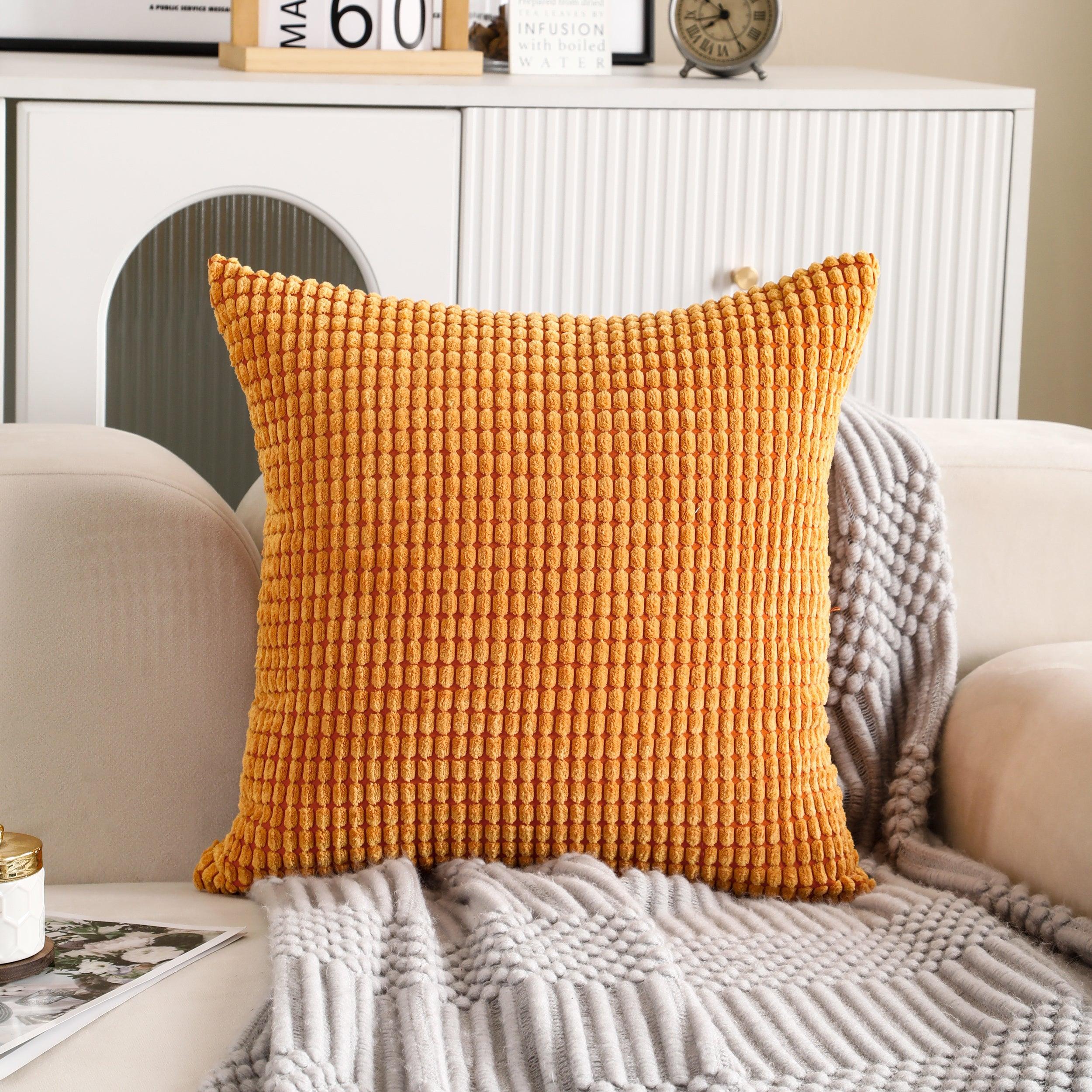 Square orange corduroy cushion cover with a soft, textured fabric