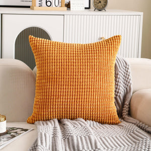 Square orange corduroy cushion cover with a soft, textured fabric