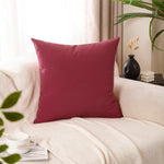 Load image into Gallery viewer, Burgundy polyester cushion covers styled on neutral sofa
