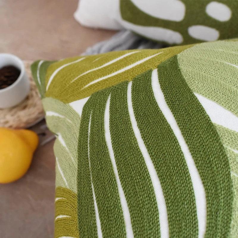 Close-up of pure cotton embroidered cushion cover with green leaves pattern