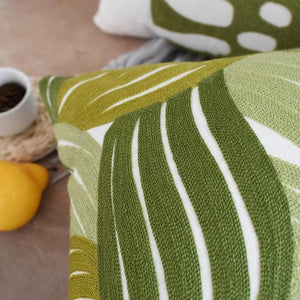 Close-up of pure cotton embroidered cushion cover with green leaves pattern