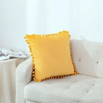Load image into Gallery viewer, Elegant velvet cushion cover with pom pom details for a cozy living room
